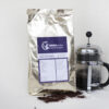 Packung kolumbianischer Kaffee French Press davor gerösteter Kaffeebohnen Alubeutel